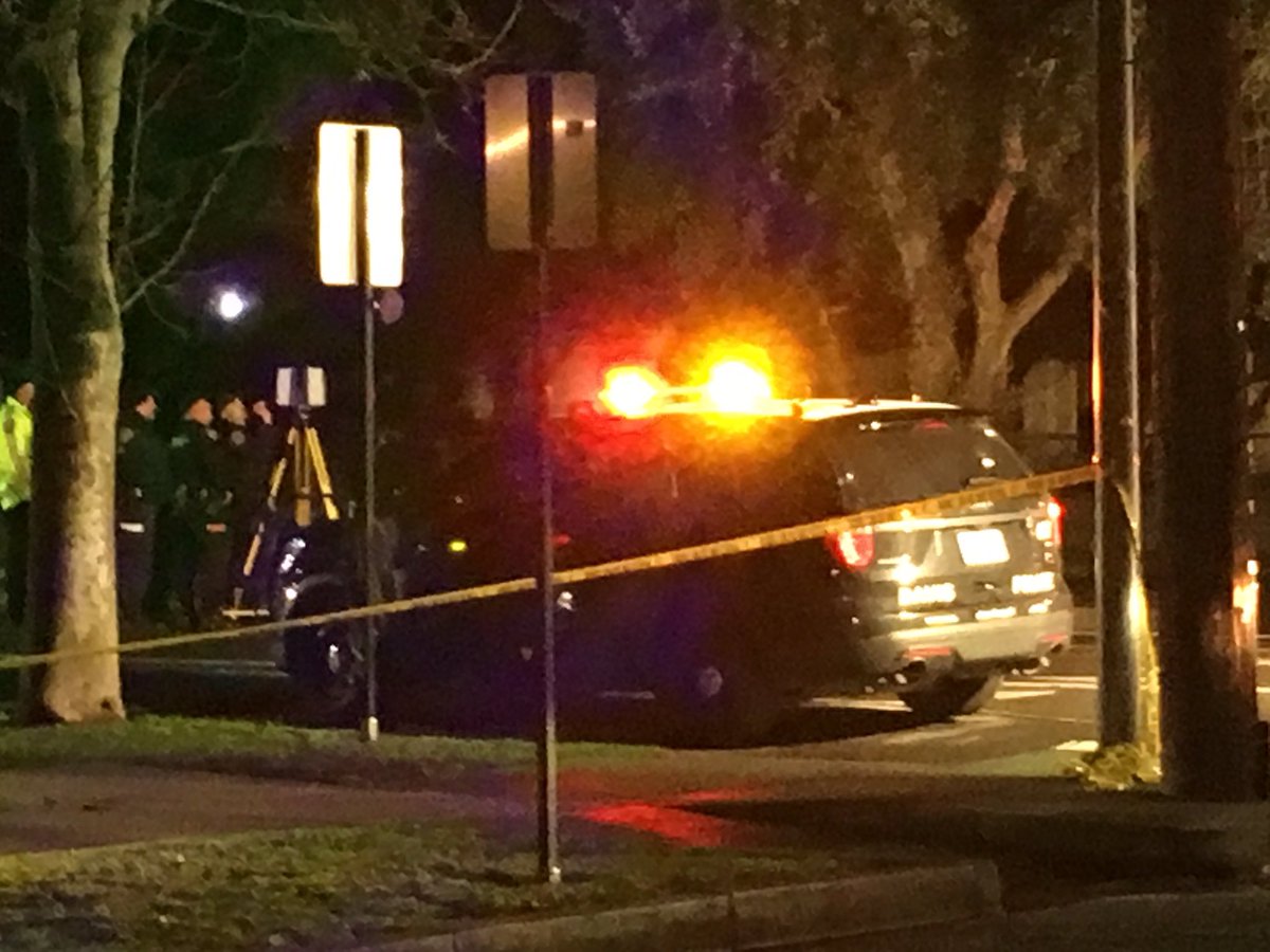 Large crime scene in downtown Davis. Officer shot and killed after responding to a car crash. A Davis police vehicle is at the scene with several bullet holes in the back window. 