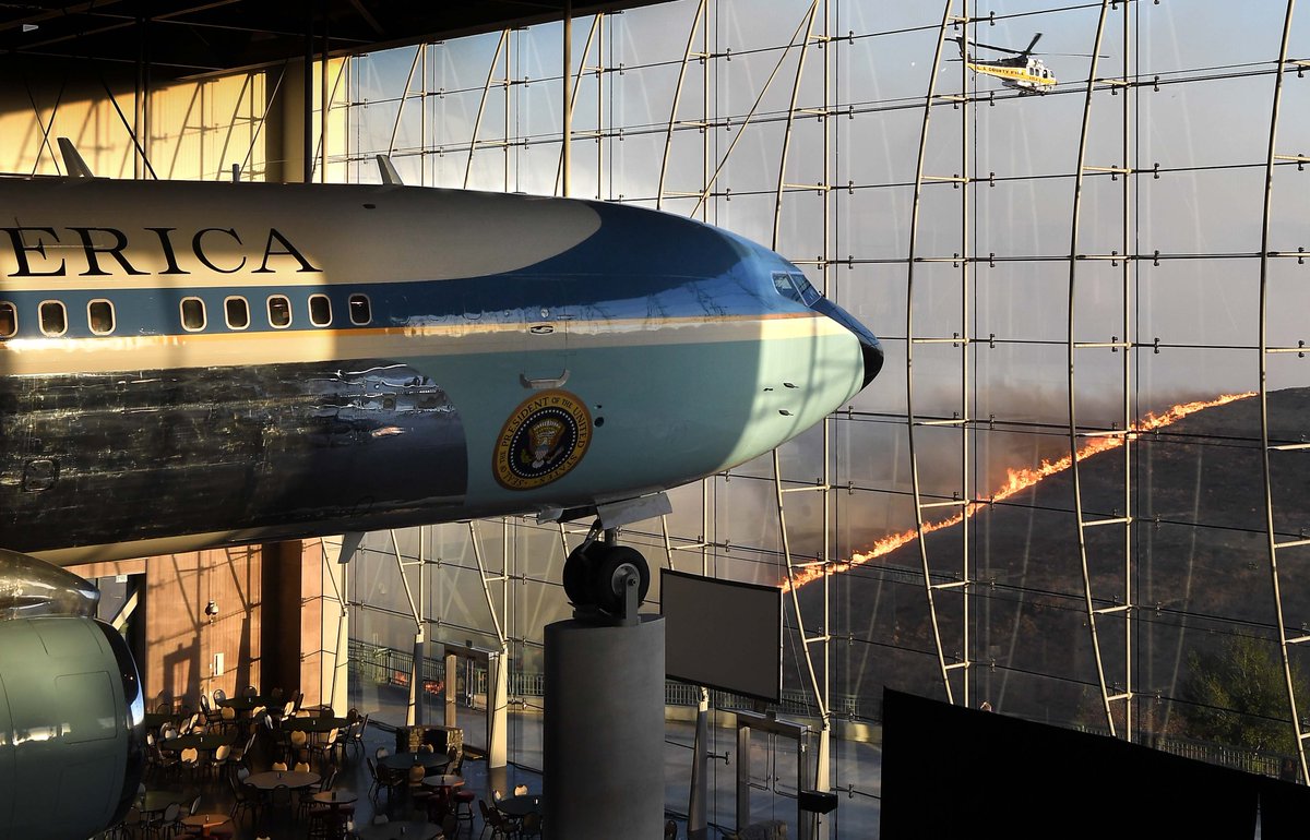 Air Force One inside the @Reagan_Library as a @LACoFireAirOps Firehawk helicopter fights the EasyFire outside