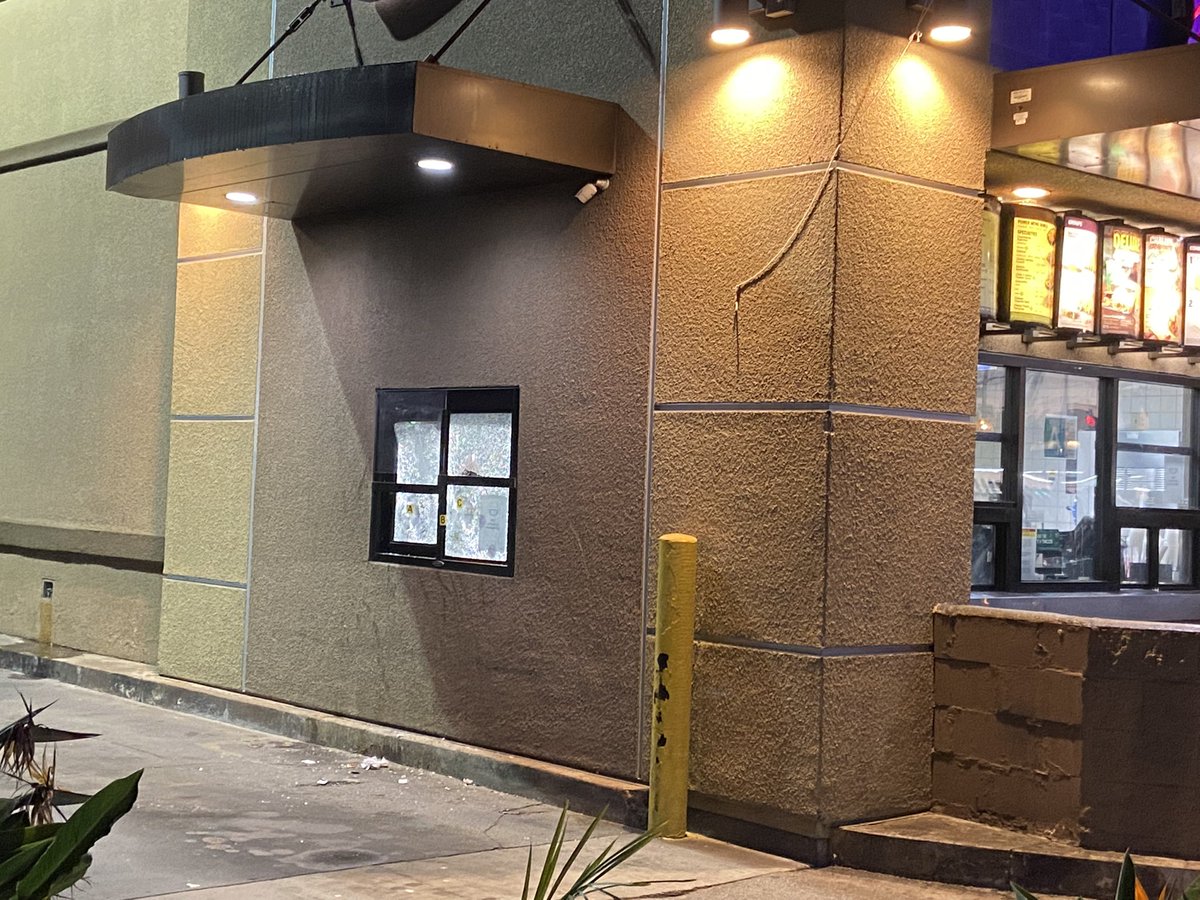 A Taco Bell employee was shot and killed, while working the drive thru, for refusing a counterfeit bill from a customer. (You can see the shattered glass in this pic)  Police are now searching for the gunman.