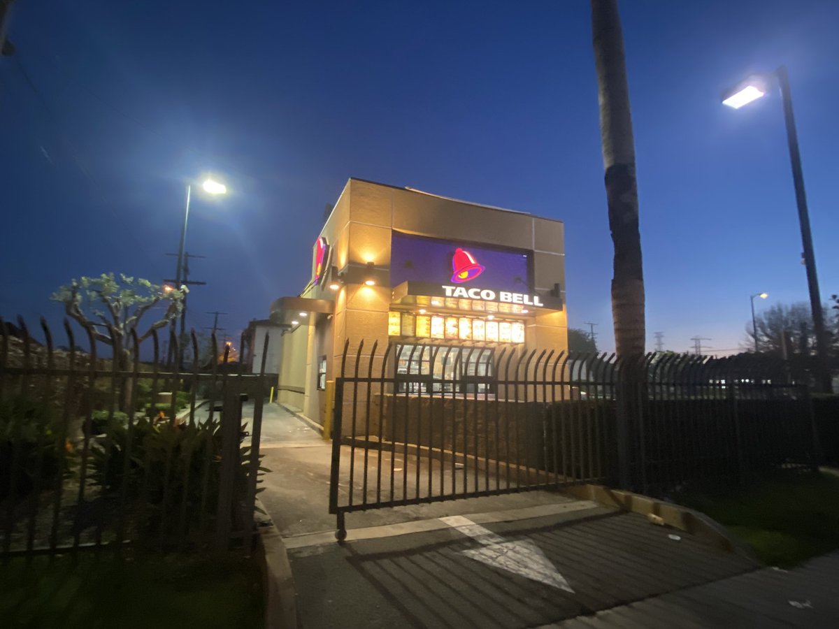 A Taco Bell employee was shot and killed, while working the drive thru, for refusing a counterfeit bill from a customer. (You can see the shattered glass in this pic)  Police are now searching for the gunman.