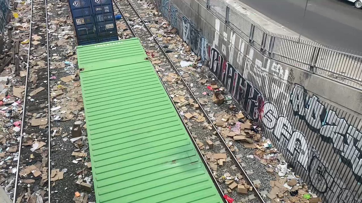 As you can see, trains frequently slow or stop in this area as they get worked into the @UnionPacific Intermodal facility  near Downtown LA. The thieves use this opportunity to break open containers and take what's inside. I'd say every 4th or 5th rail car had opened containers