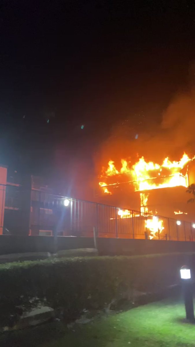 Someone with a hose is trying to knock down the flames at Park Newport tonight. Part of the apartment complex on Jamboree Rd in Newport Beach is burning