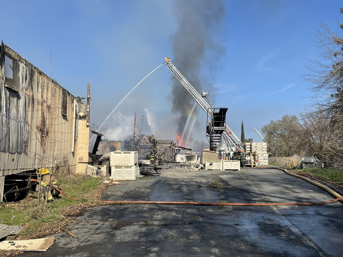 Fire continues burning in the hundreds of bins stacked around the property edges. A column of black smoke can periodically be seen as the fire finds the right fuel and oxygen combination and flames flare up. We continue to have 5 engines and a BC committed