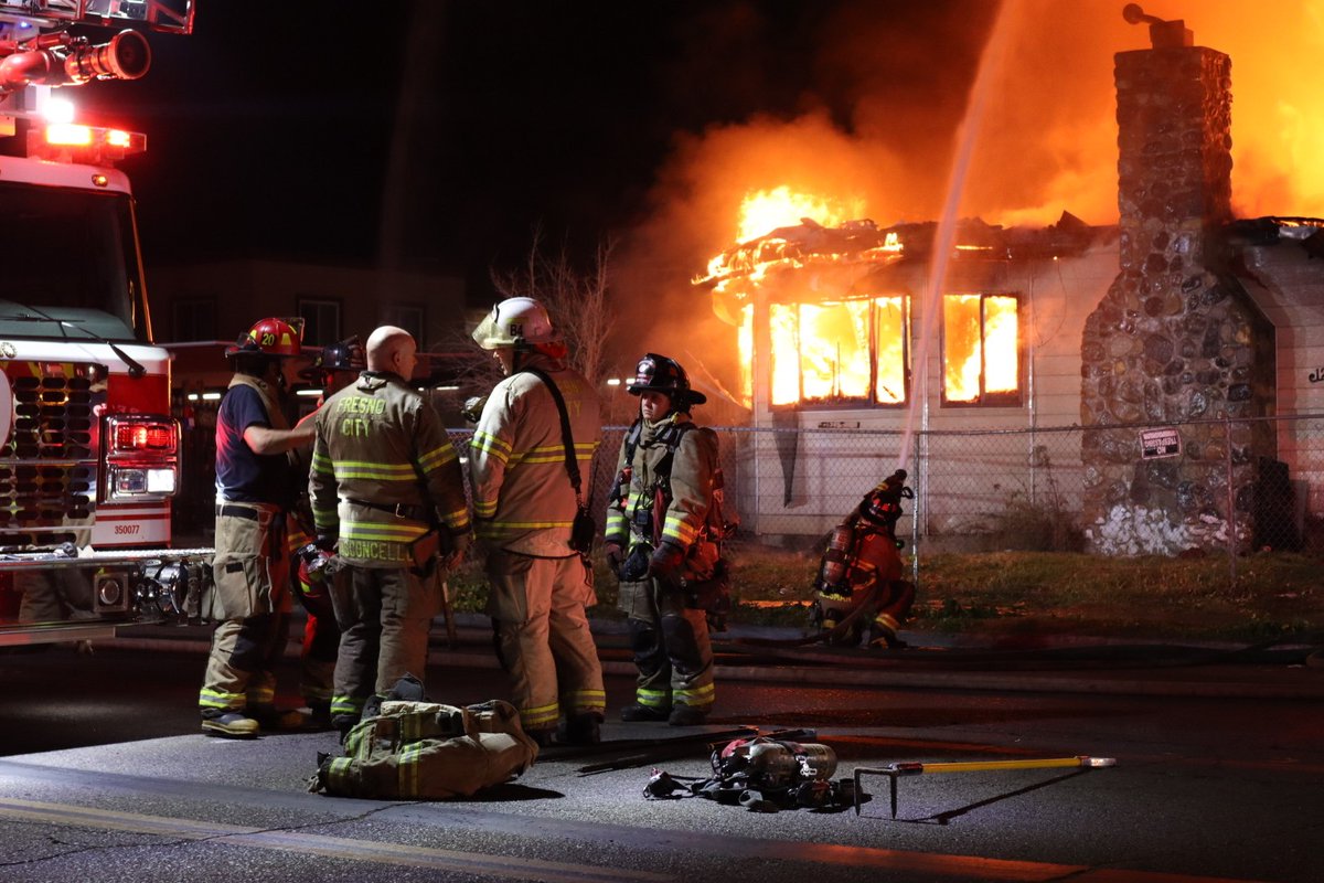 Several crews are battling a large house fire in northwest Fresno