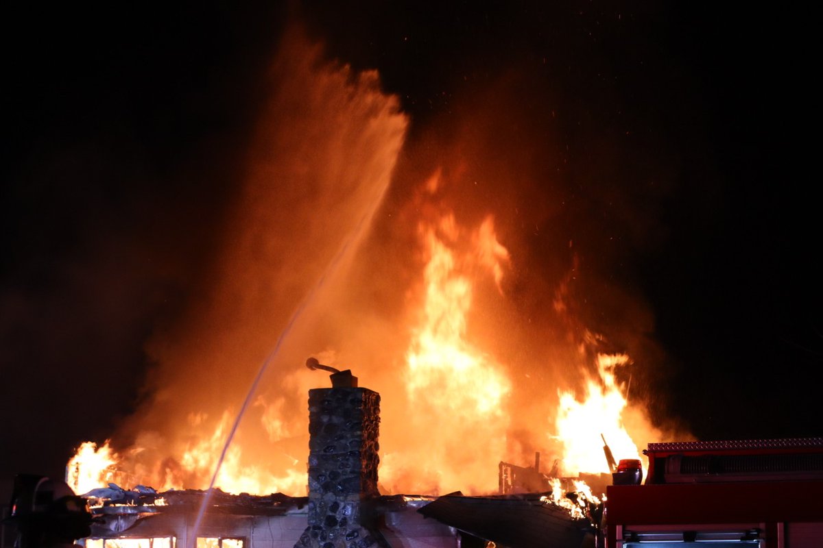 Several crews are battling a large house fire in northwest Fresno