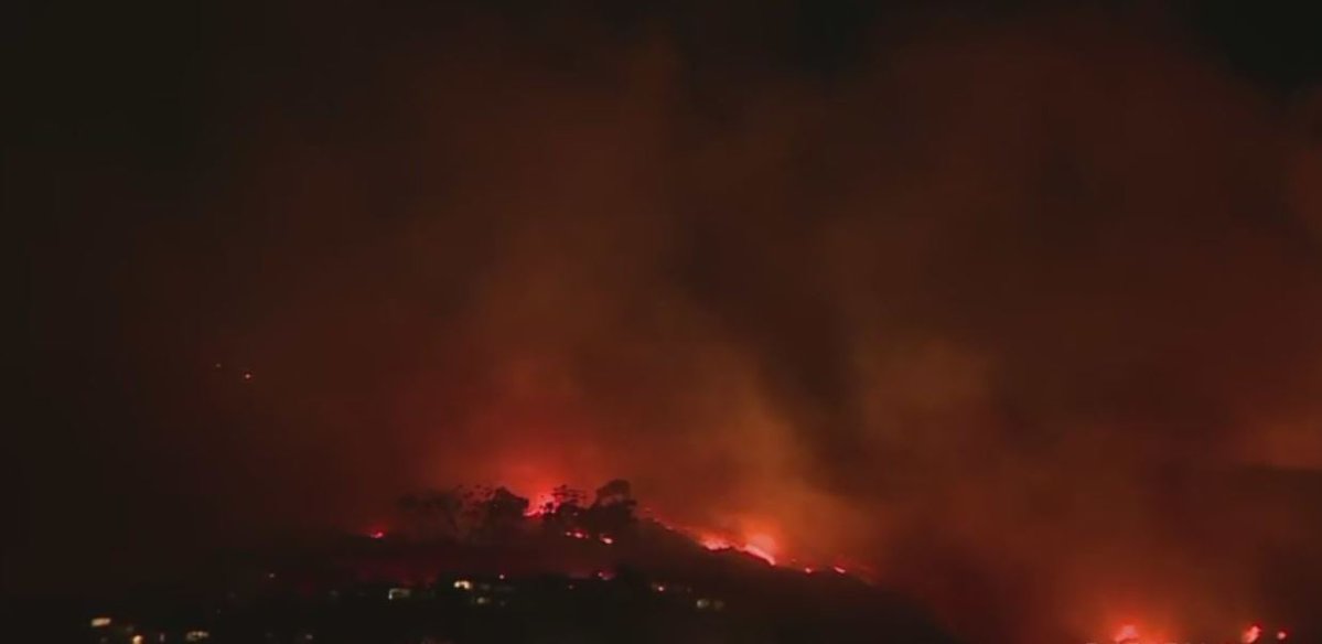 A large brush fire is burning in the Emerald Bay area of Laguna Beach amid powerful Santa Ana winds.