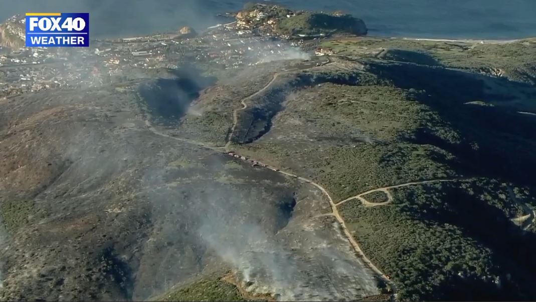 dry the brush is and how close to coast the Emerald Fire is burning