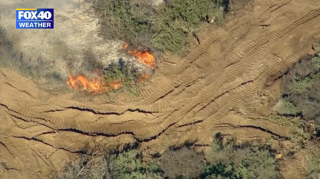 Firefighters working on creating a firebreak to halt the spread of the Emerald Fire towards the populated coastline