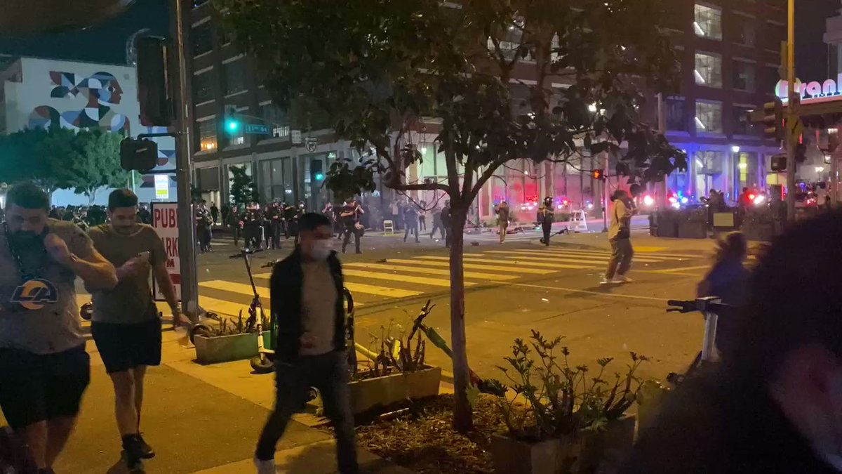 LAPD officers are firing projectiles at people in downtown Los Angeles