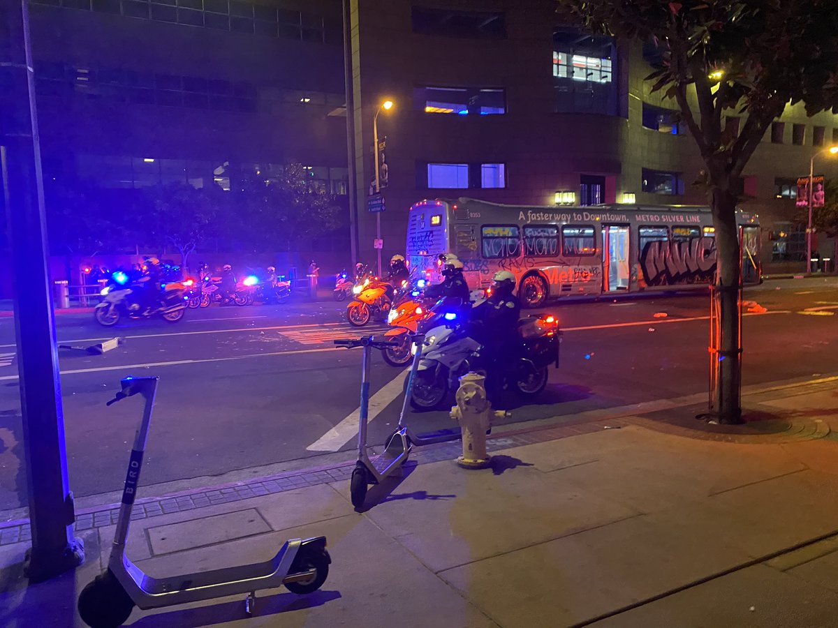 People got inside the bus and were setting off fireworks inside of it. It's smoking. One person just passed me holding his injured hand screaming fuck.  Police moved in on bikes with sirens blazing — and crowd ran off