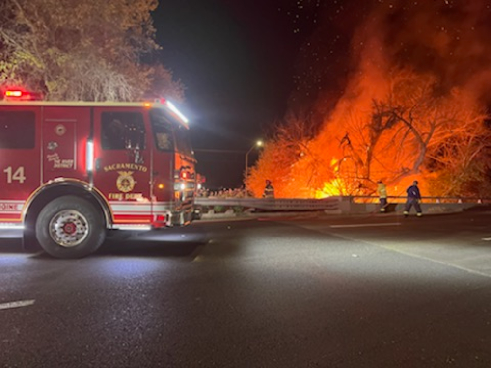 VegetationFire  N 12th and Richards Blvd  Sacramento Fire crews are on scene of a large vegetation fire in the area of Highway 160 and N 12 St.  The brush fire was approaching the lines for the light rail and it was requested to shut down light rail traffic