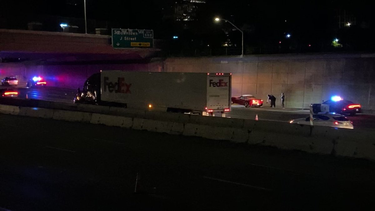 Is towing this red sports car off NB Interstate 5   in Sacramento just before the J Street off ramp. still trying to figure out why the interstate has been reduced to one lane. CHP is investigating