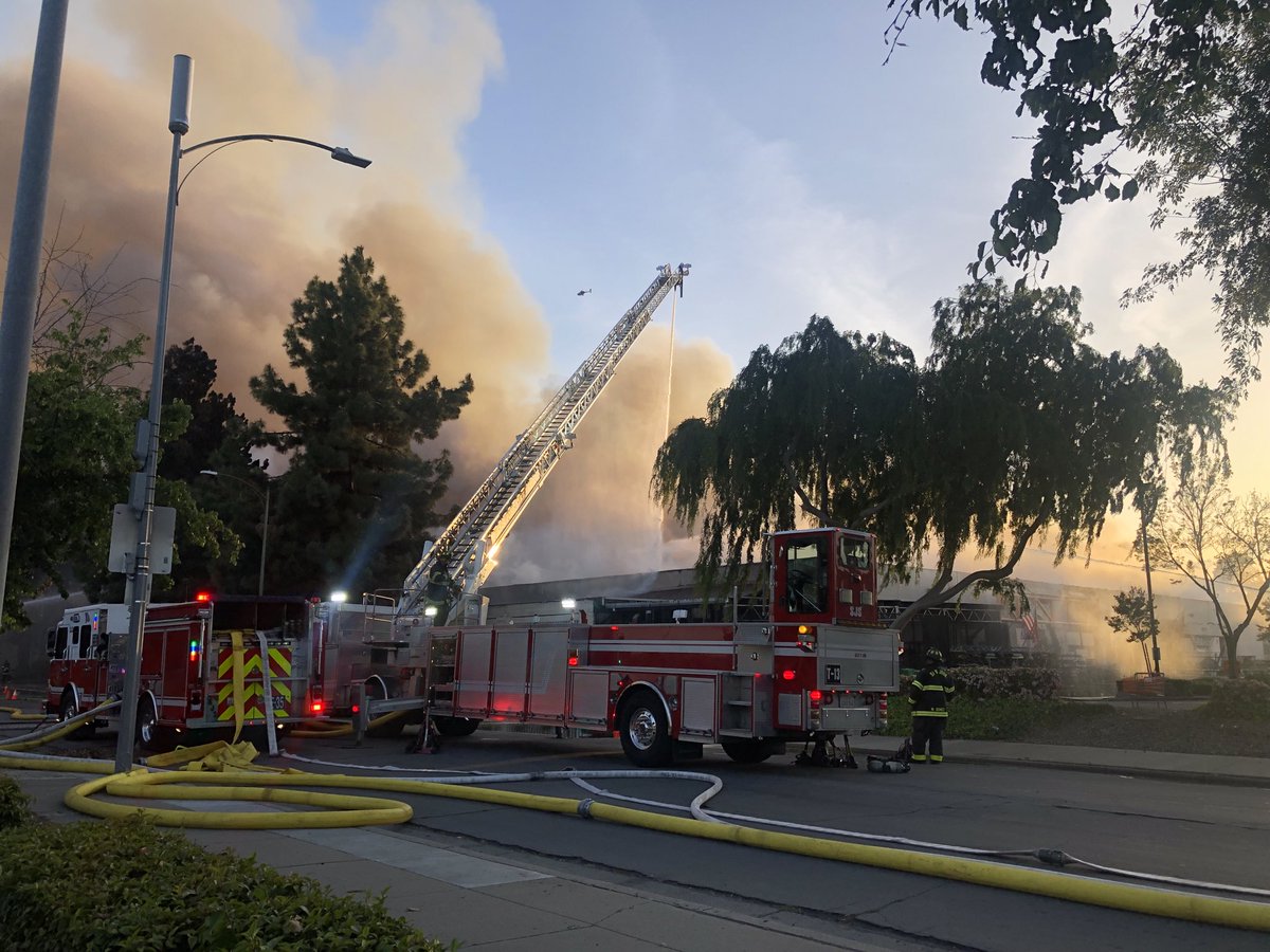 San Jose firefighters making progress battling a 5 alarm fire at the Home Depot on Blossom Hill road across the street from Oakridge mall. Using aerial streams to douse fire. Concerns about embers spreading to homes directly behind building. No reports of injuries