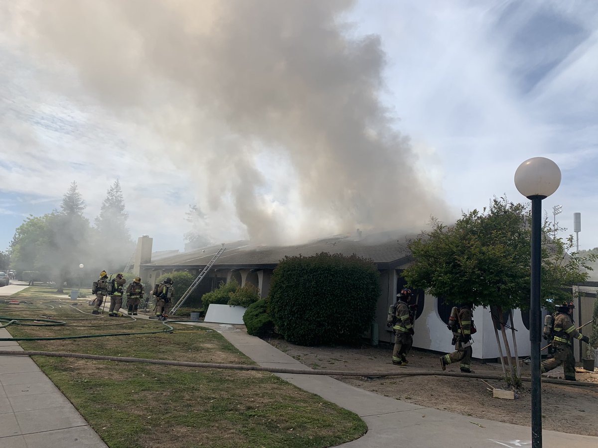 It looks like firefighters have things mostly under control. I overheard them talking about an offensive strategy and trying to isolate the fire to the attic. It hasn't spread out further than this building. No word yet one how the fire started