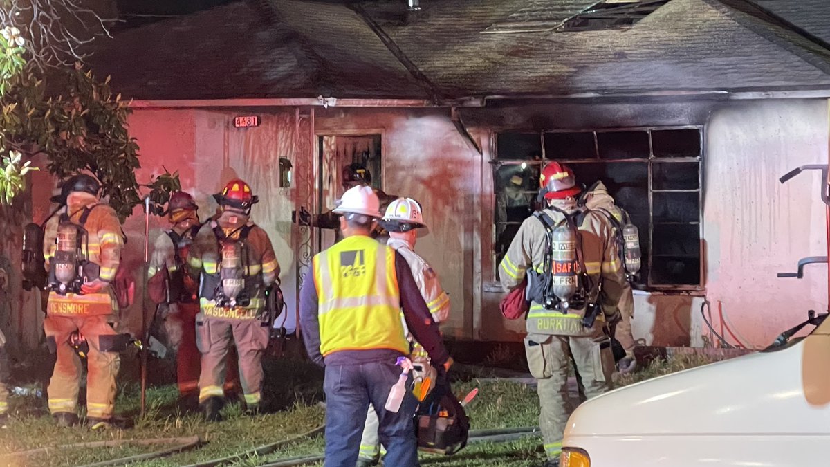 At least one person was pulled from a burning home Thursday night in Fresno