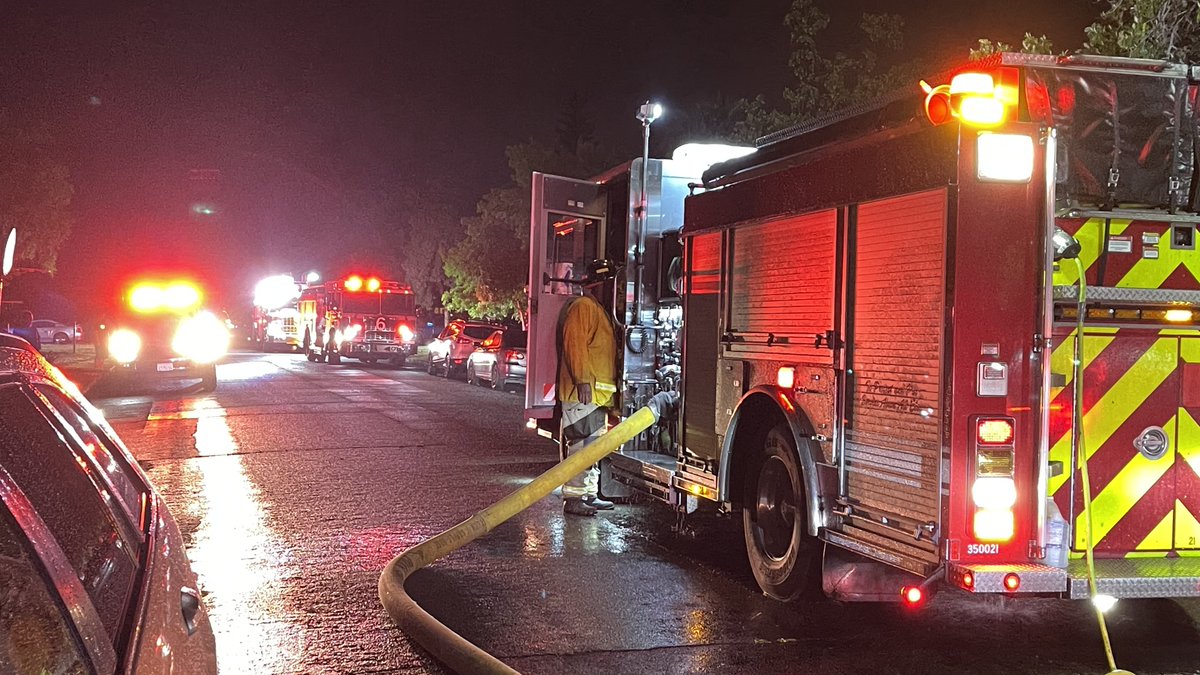 At least one person was pulled from a burning home Thursday night in Fresno