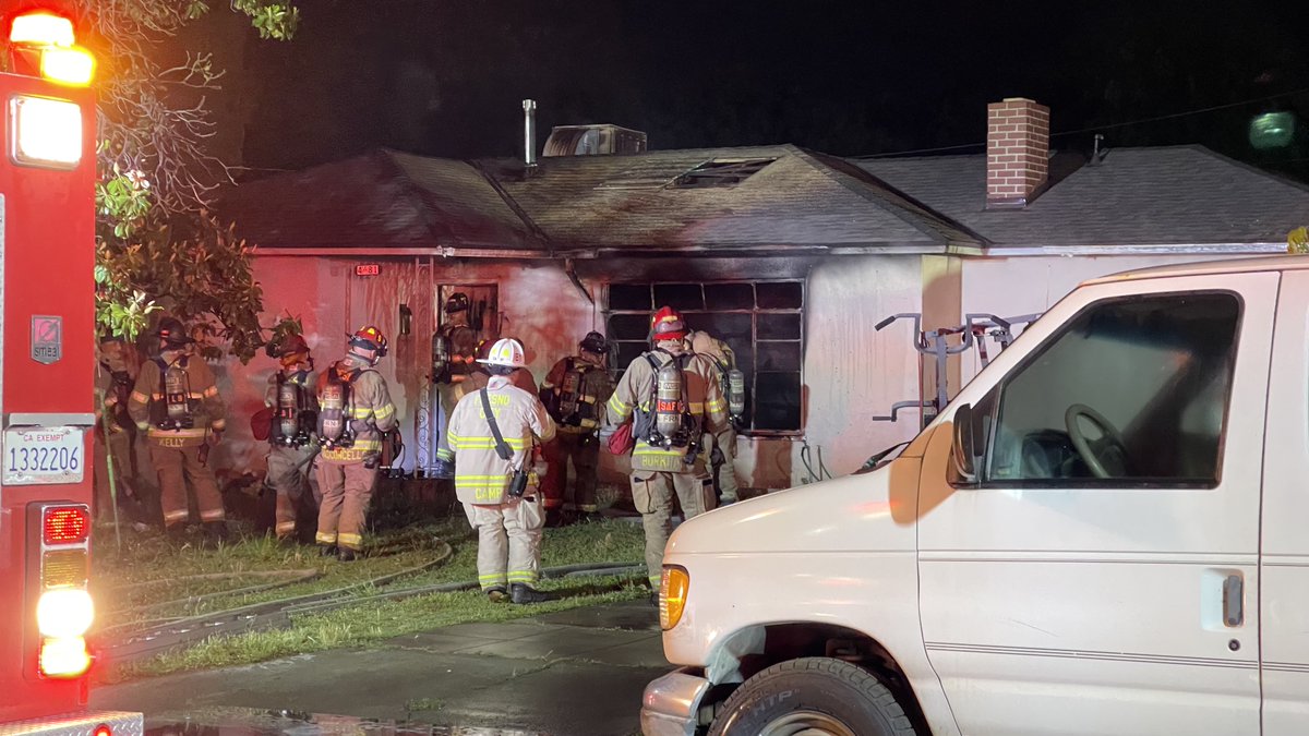 At least one person was pulled from a burning home Thursday night in Fresno