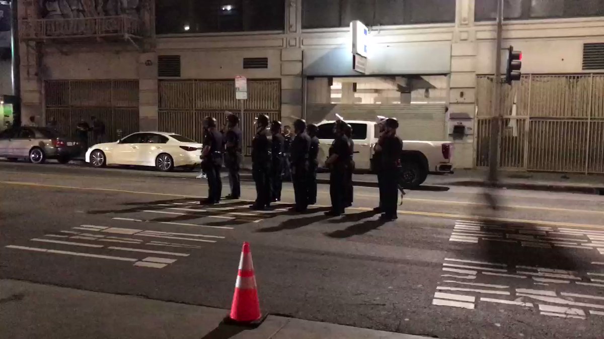 Handful of protesters in standoff with lapd . Officers in riot gear moved in to clear out the crowd.  One officer hurt. Hill b/w 4th and 5th shut down.