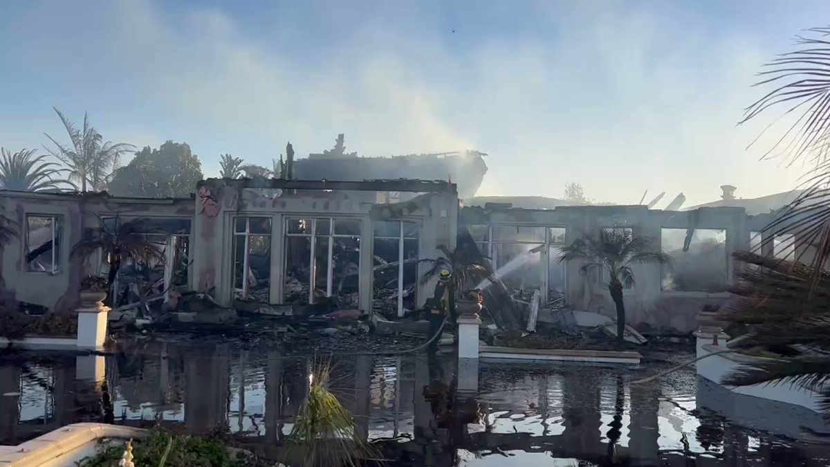 The backside of 5 Vista Court in Laguna Niguel this morning as firefighters continue putting out hotspots. The second floor collapsed so there's a lot of hot and still-smoldering debris