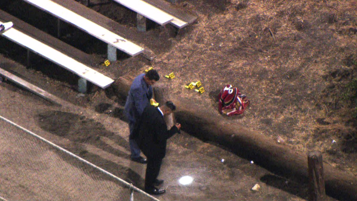 LAPD detectives are gathering evidence tonight at PeckPark in SanPedro where 2 people were killed and 5 injured in a shooting today. Dozens of yellow evidence markers are scattered around the park's baseball field and bleachers as well as in the adjacent parking lot