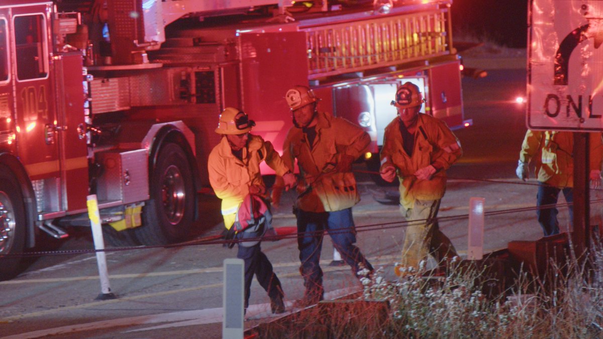 Crews from Fire Station 150's engine company and hazmat squad, Paramedic Squad 73 and Quint 104 worked together to lower a stokes basket down the embankment to the crash location