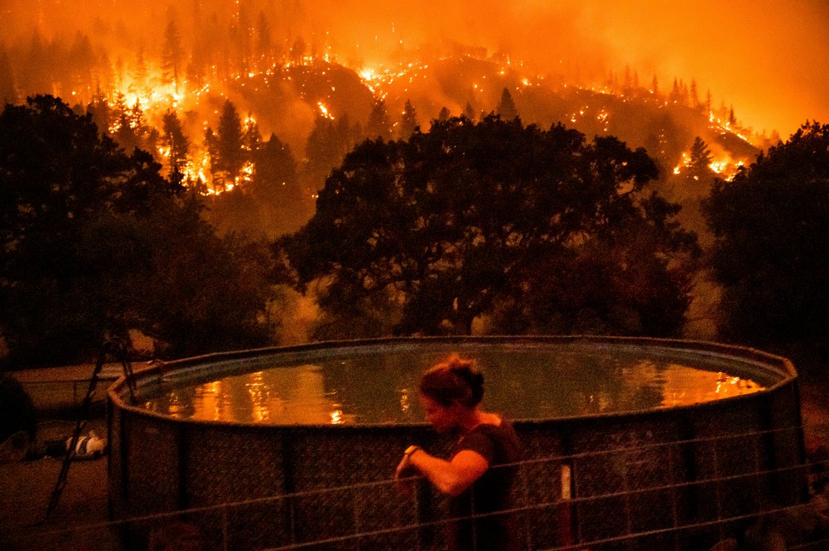 Two bodies were found inside a charred vehicle in a driveway in the wildfire zone of a raging California blaze that is among several burning in the western U.S. amid hot, dry and gusty conditions that boost the danger that the fires will keep growing