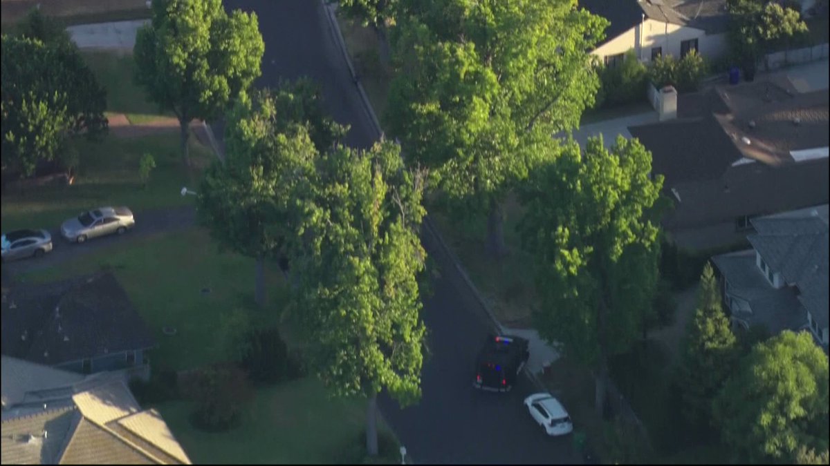 A SWAT team used an armored vehicle to rescue an officer that was taking cover behind a tree. The officer appeared to be limping when the SWAT team ushered him into the back of the armored truck