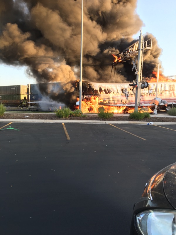 A semi-truck driver is dead after crashing into an ongoing train in Kingsburg, then goes up in flames with several explosions.  