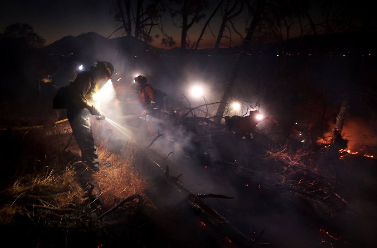 Crews work to tie in containment lines on the steep slopes of the PointFire near Lower Lake, Ca., Saturday evening