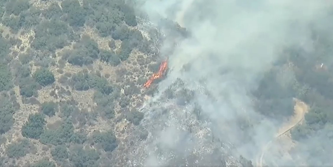 Brush fire erupts in San Gabriel Canyon area above Azusa, prompting multi-agency response from firefighters.