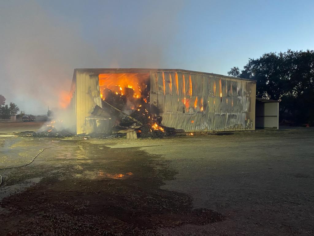 Firefighters are at scene of a Hay bay Fire in a large metal hay barn off of W Biggs Gridley Rd. Firefighters protecting Residences around the building as well as trying to extinguish the fire