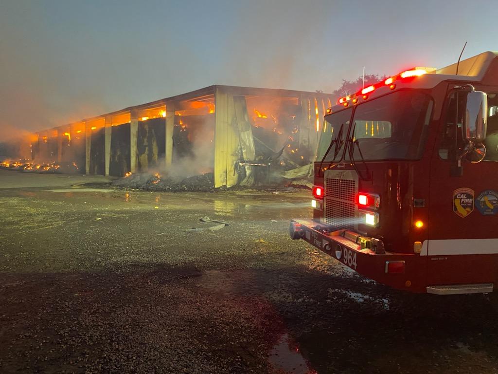 Firefighters are at scene of a Hay bay Fire in a large metal hay barn off of W Biggs Gridley Rd. Firefighters protecting Residences around the building as well as trying to extinguish the fire