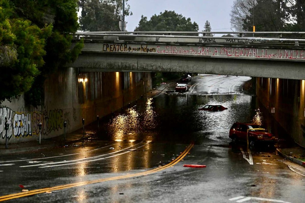 Two cars were stuck in a flooded underpass at 34th and Webster in Oakland 