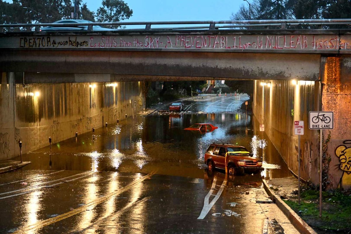 Two cars were stuck in a flooded underpass at 34th and Webster in Oakland 