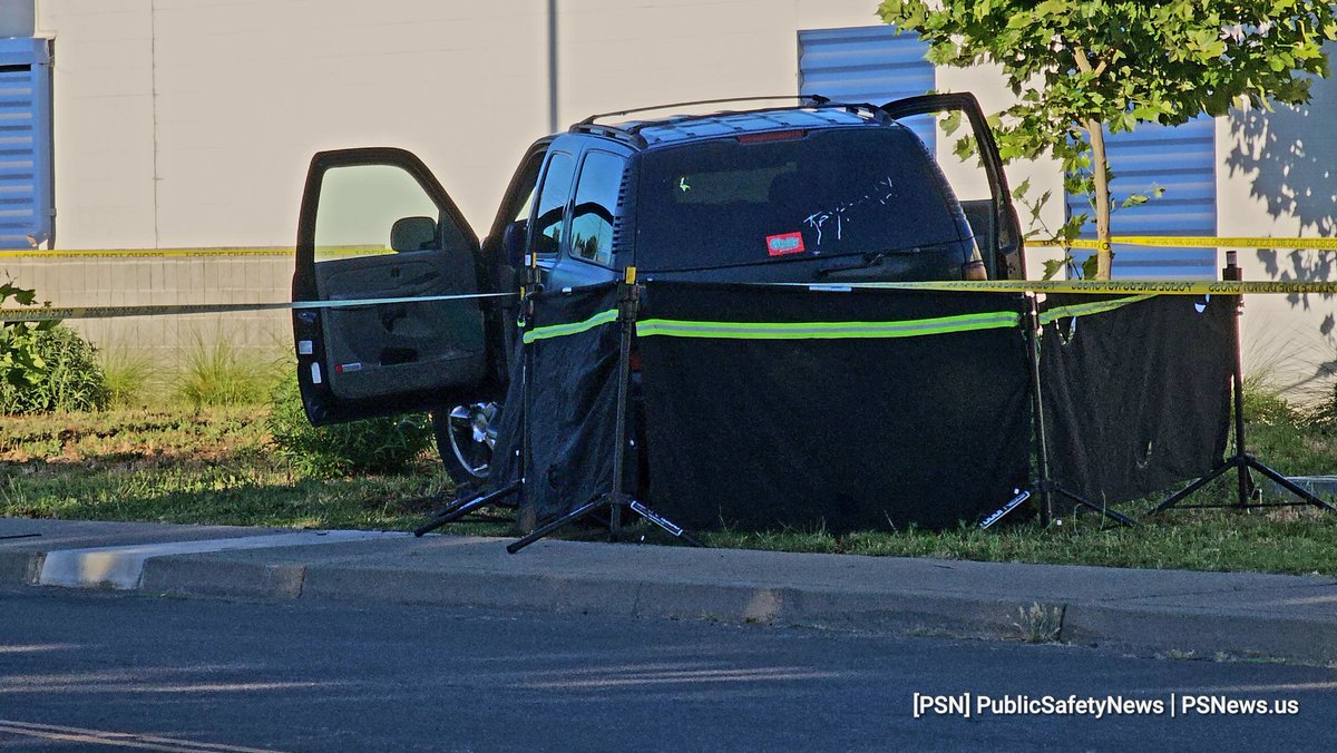 According to unofficial reports, there is a deceased person under this SUV on the lawn, located on the east side of Life Storage, on Kelton Way, just north of Main Ave, and south of Sumatra Dr