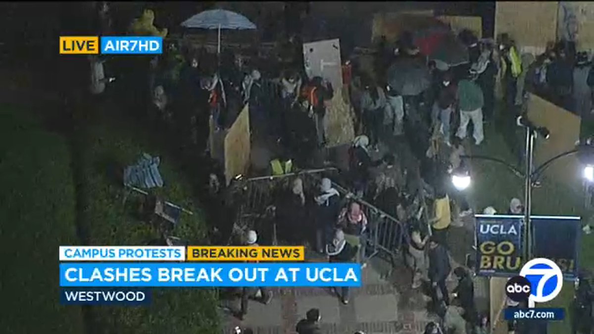 Protesters at UCLA are carrying barricades and pushing them into opposing groups: police are still not on scene  About 7 police units have just driven up to UCLA campus near protest site as two sides throwing objects at each other
