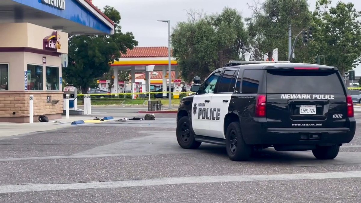 Police activity surrounds a Chevron gas station in Newark