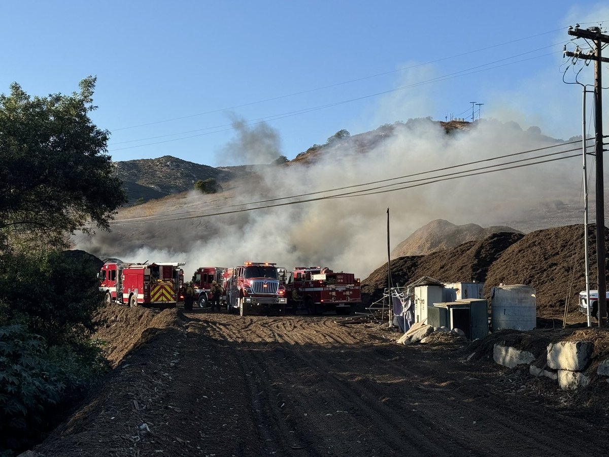 .@CALFIRESANDIEGO firefighters are at scene of a large mulch pile fire in the 12000 block of Slaughterhouse Canyon Road in Lakeside. There is no extension into the vegetation and resources from the air and ground are making good progress