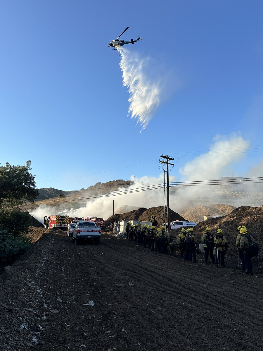 .@CALFIRESANDIEGO firefighters are at scene of a large mulch pile fire in the 12000 block of Slaughterhouse Canyon Road in Lakeside. There is no extension into the vegetation and resources from the air and ground are making good progress