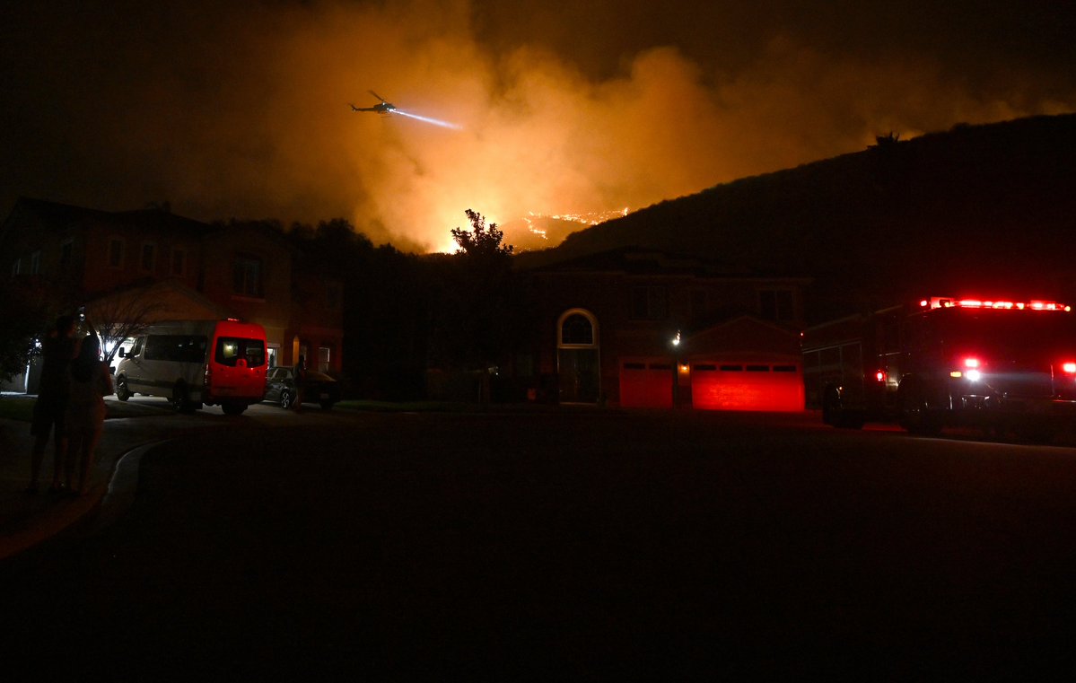 The linefire burns above homes in Highland, CA Thursday night