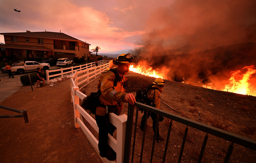 Firefighters try to keep the Line fire away from homes on Emmerton Lane in Highland on Saturday evening Sep. 7, 2024. 