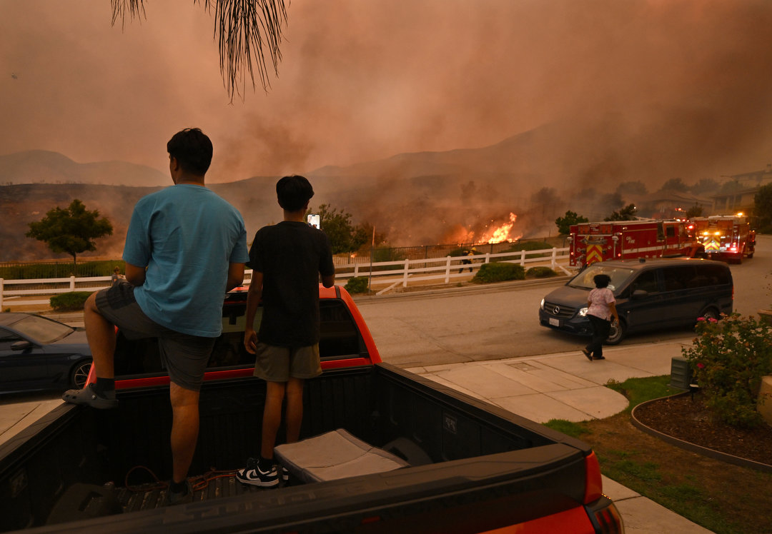 Firefighters try to keep the Line fire away from homes on Emmerton Lane in Highland on Saturday evening Sep. 7, 2024. 