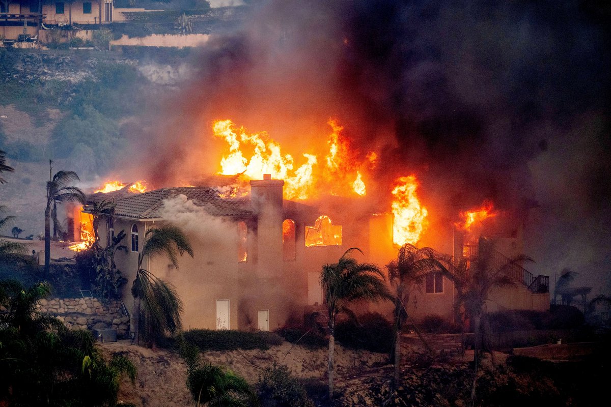 Thousands of people evacuated as wildfires ravage homes near Los Angeles