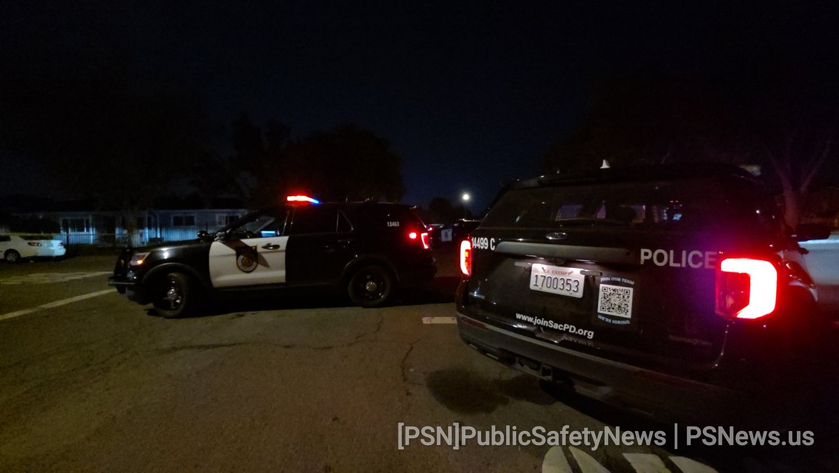 Body on the ground behind privacy screens.  The scene is still very active with closures and crime scene tape in place. CSI and detectives are actively working