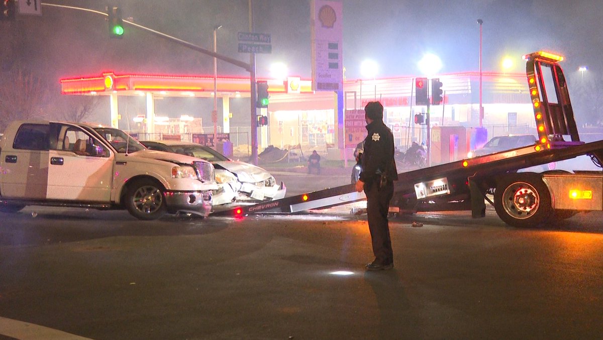 Two people were injured after police say a driver ran a red light, crashing into a pickup truck that was making a turn