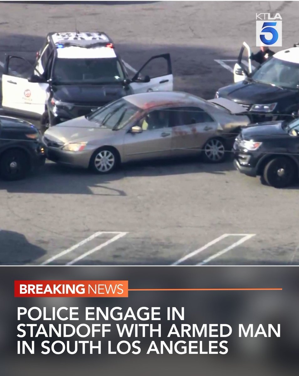 Police are engaged in a standoff with an armed man inside a truck in South Los Angeles.