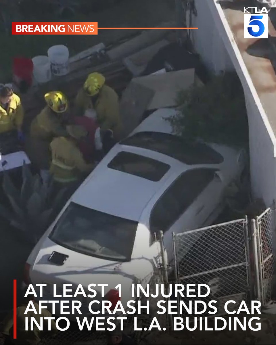 At least one person has been sent to the hospital after firefighters freed the driver of a car that slammed into a building in West Los Angeles on Monday morning